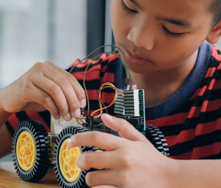 Desktop young boy building car